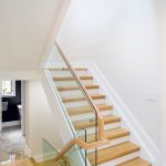 custom-staircase-with-wooden-floor-and-glass-railings-home-renovation-contractors