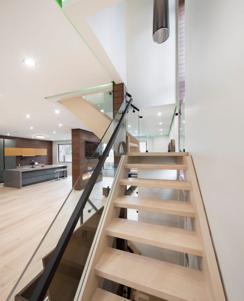 second-floor-staircase-with-glass-railings-and-green-backlit-ceiling-interior-designers-toronto-and-GTA