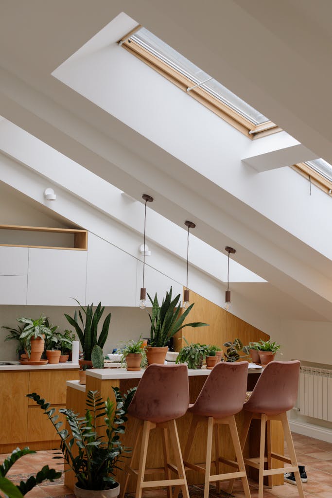Spacious kitchen with skylights, plants, and wooden decor, creating a calming natural ambiance.