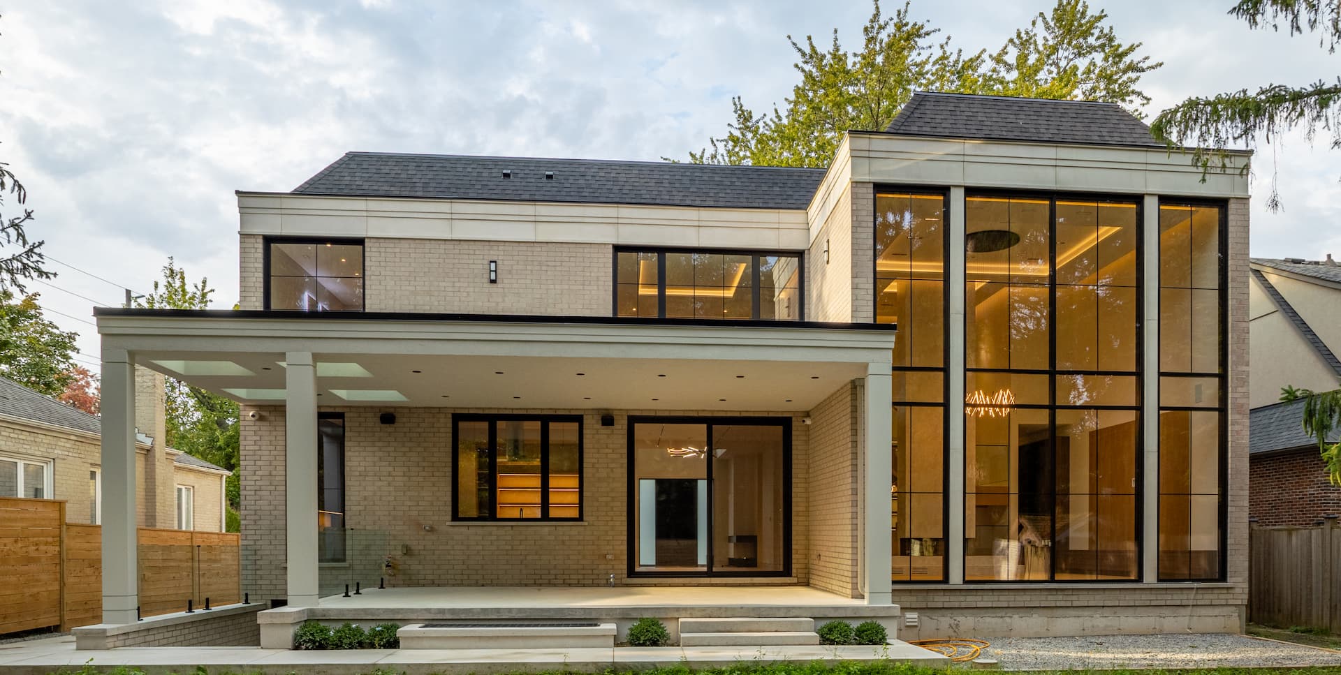 Completed two-storey Toronto-area home addition with a contemporary glass entrance